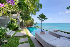 a villa with a swimming pool next to the ocean at The Headland Villa 2, Samui in Koh Samui 