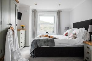 a bedroom with a large bed and a window at Number Seven in Newquay