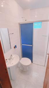 a bathroom with a toilet and a sink and a shower at Nacional Park Hotel Lages in Lages