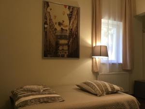 a bedroom with a bed with a lamp and a window at Corso Quiet in Budapest