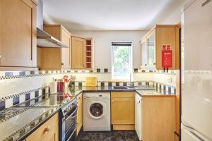 a kitchen with a washer and a washing machine at Seaview in Llandegfan +12 photos
