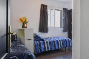 a small bedroom with a bed and a window at Casa Conchita in Playa Honda +19 photos