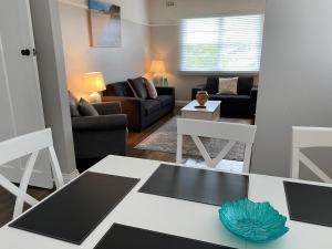 a living room with a couch and a table at Daisy Cottage on Duke 3BR in Yarram