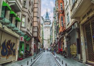 a city street with a clock tower in the distance at Maravilloso Hotel Galata in Istanbul