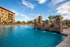
a large stone building with a pool of water in front of it at Wekopa Casino Resort in Fountain Hills
