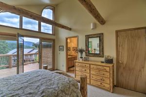 a bedroom with a bed and a dresser and a mirror at Rustic Home on Whitefish Mountain, Near Ski Run! in Whitefish