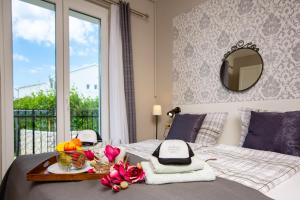a bedroom with a bed with a tray with flowers on it at Villa Riva in Barbat na Rabu