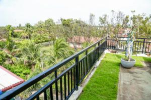 a balcony with a view of a garden at Nebula Residence in Negombo