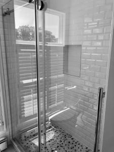 a shower stall with a window in a bathroom at Old Town Inn in New Shoreham