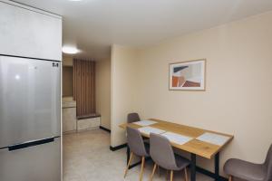 a dining room with a table and a refrigerator at VIP Flat lavina проспект М Лушпи 2 корп2 in Sumy