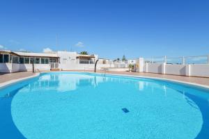 a large blue swimming pool on top of a building at Casa Conchita in Playa Honda