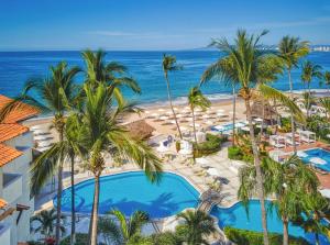 an aerial view of the resort with palm trees and the ocean at Buenaventura Grand Hotel & Great Moments - All Inclusive in Puerto Vallarta