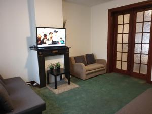 a living room with a flat screen tv and a couch at 1-2 bedroom apartments close to EU district. in Brussels