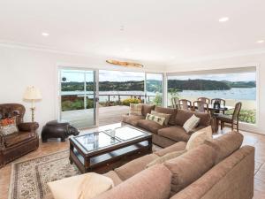a living room with a couch and a table at Captain's Quarters - Opua Holiday Home in Opua
