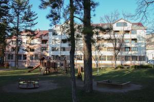 a large building with a playground in a park at Apartman "Park" in Livno