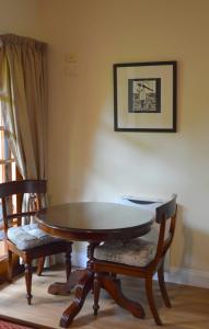 a living room with a table and chairs at Meredith House in Swansea