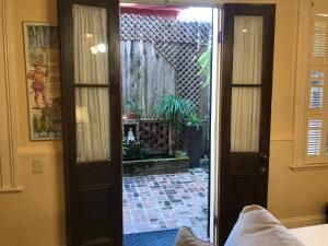 a door that is open to a room with a window at The Courtyards in New Orleans