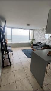 a living room with a couch and a table at condominio costa peñuelas torre 2 in Coquimbo