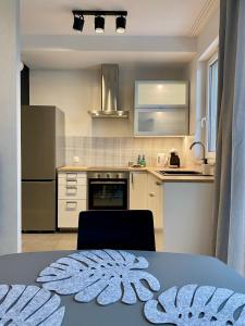 a kitchen with a table and a counter top at Panoramic view apartments Warsaw West II in Warsaw