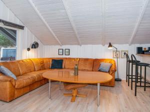 a living room with a couch and a table at 6 person holiday home in Ringk bing in Klegod
