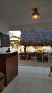 a resort with a beach with chairs and umbrellas at Cabôco Sonhadô Passeios Náuticos e Pousada in Mundaú