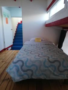 a bedroom with a bed and a staircase at Hostel Mexico DF Airport in Mexico City