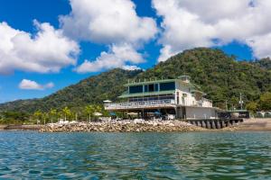 a large house on the shore of a beach at Amaka Ocean Living Lodge in Golfito