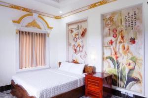 Postel nebo postele na pokoji v ubytování Little Saigon Hotel