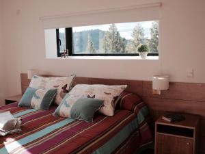 Ένα ή περισσότερα κρεβάτια σε δωμάτιο στο Casa de Montaña Golf & Polo - San Martin de los Andes