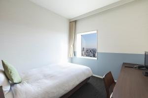 Postel nebo postele na pokoji v ubytování Hotel Crown Hills Ueno Premier