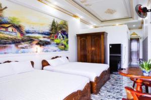 Postel nebo postele na pokoji v ubytování Little Saigon Hotel