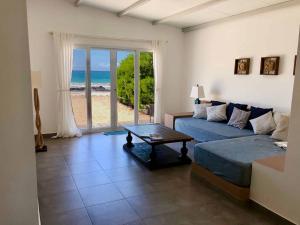 a living room with a couch and a table at Sandy Feet House in Puerto Villamil