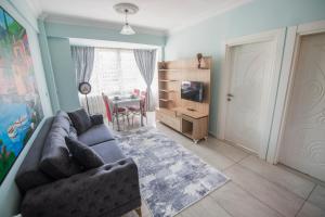 a living room with a couch and a table at Melodi Hotel in Isparta