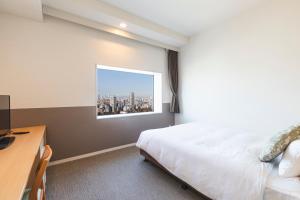 Postel nebo postele na pokoji v ubytování Hotel Crown Hills Ueno Premier