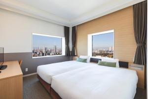 Postel nebo postele na pokoji v ubytování Hotel Crown Hills Ueno Premier