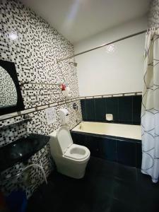a bathroom with a toilet and a bath tub at Ct Hotel in Sitiawan +55 photos