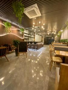 a dining room with tables and chairs and lights at Khánh Phong Apartment in Waterfront in Hai Phong