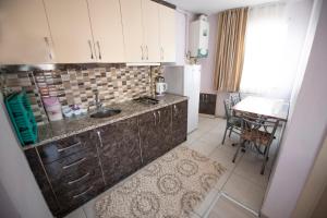 a small kitchen with a sink and a table at Liman Apart Hotel in Isparta