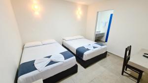 Postel nebo postele na pokoji v ubytování Hotel Vista Laguna Bacalar