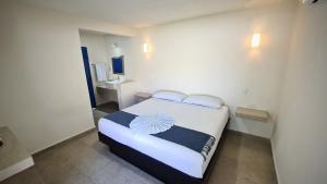 Postel nebo postele na pokoji v ubytování Hotel Vista Laguna Bacalar