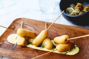 a bunch of food on a wooden cutting board at Kimpton - Sylvan Hotel, an IHG Hotel in Atlanta