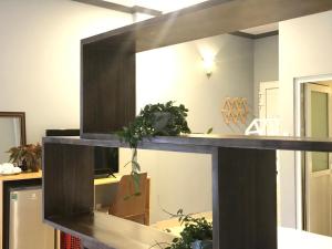 a mirror in a room with some plants on it at CozyNook Boutique Apartments - 3 thang 2 Street in Da Lat