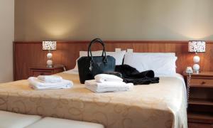 
a bed with a suitcase on top of it at Hotel Ortegal in Mar del Plata
