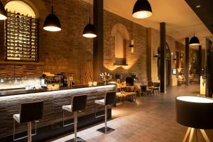 a restaurant with a bar with chairs and tables at Schlosshotel Blankenburg in Blankenburg