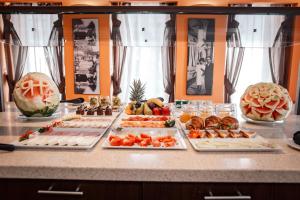 a buffet with many different types of food on a counter at River Palace Hotel in Atyraū