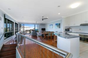 a kitchen and dining room with a view of the ocean at Fig Tree Down in Point Lookout