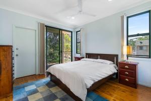 a bedroom with a bed and a window at Fig Tree Down in Point Lookout