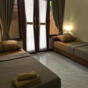 Postel nebo postele na pokoji v ubytování Bulan Bali Guest House