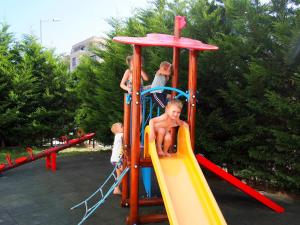 a group of children playing on a playground at Бяла Виста Бийч Апартментс A - Byala Vista Beach Apartments A in Byala