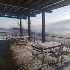 a group of tables and chairs in the snow at Rooms Bolfan Vinski Vrh in Hrašćina